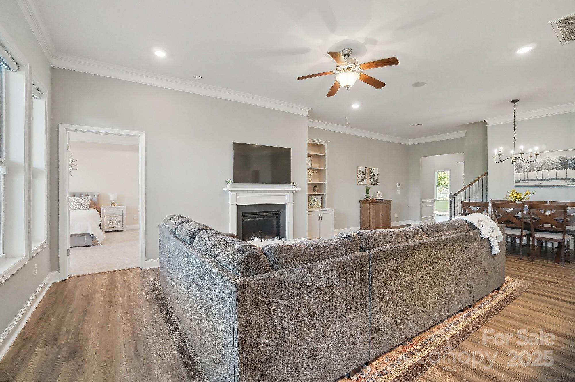 5004 Oakmere Road Waxhaw, NC 28173 - Photo 7 of 48 a living room with furniture a fireplace and a flat screen tv