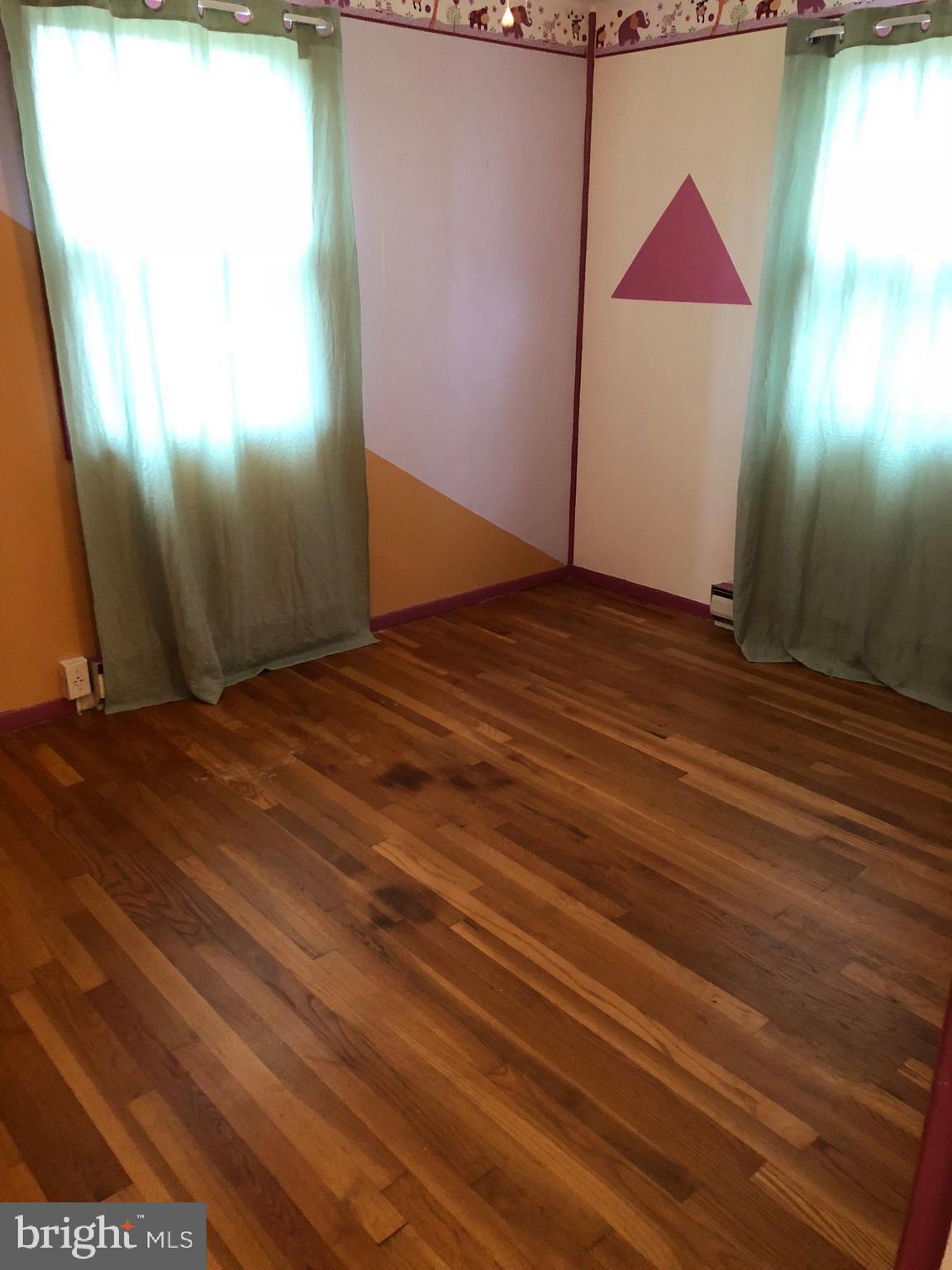 11804 Warner Road Keymar, MD 21757 - Photo 4 of 9 a view of an empty room with wooden floor