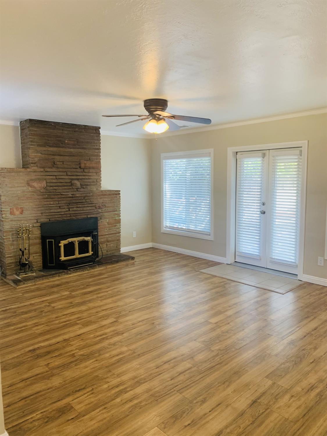 1163 Roxanne Avenue Hayward, CA 94542 - Photo 14 of 18 an empty room with wooden floor fireplace and windows