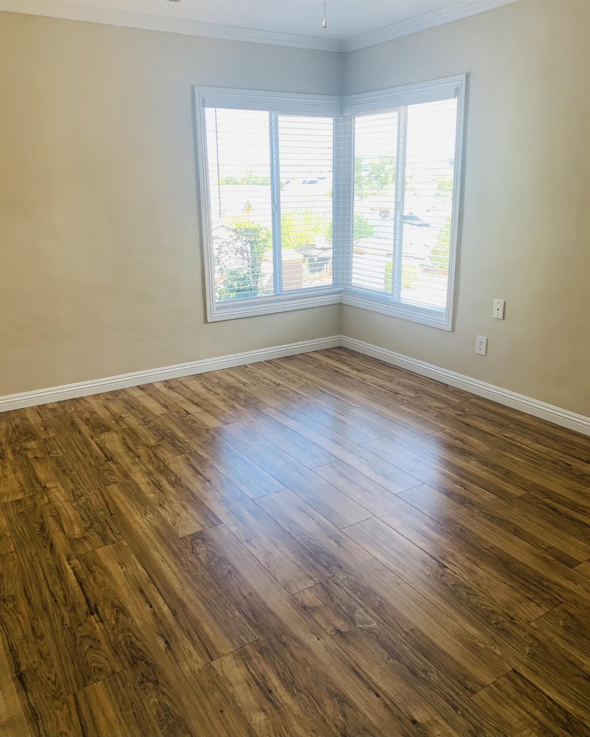 1163 Roxanne Avenue Hayward, CA 94542 - Photo 15 of 18 an empty room with wooden floor and windows