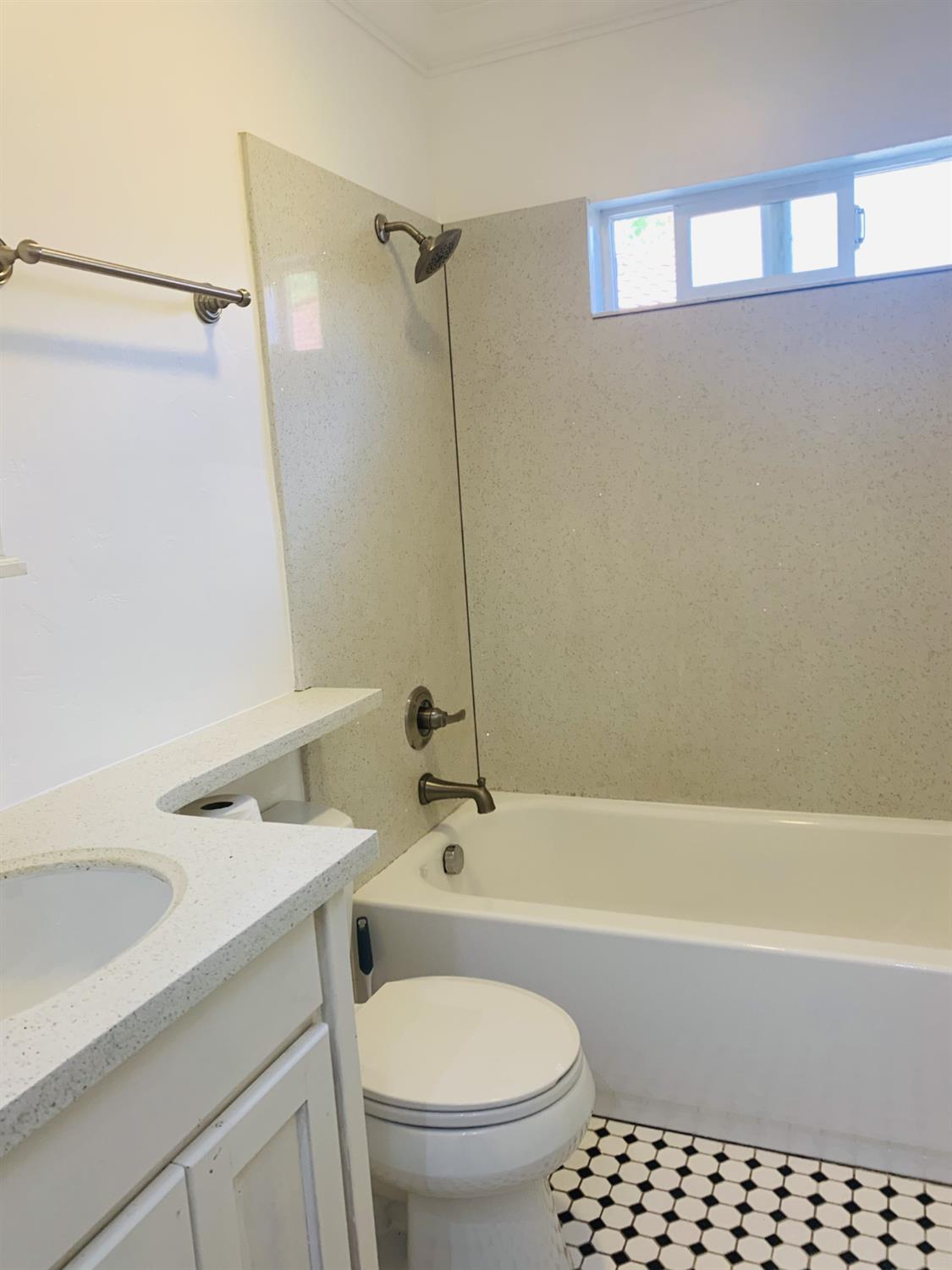 1163 Roxanne Avenue Hayward, CA 94542 - Photo 8 of 18 a bathroom with a sink a toilet and shower