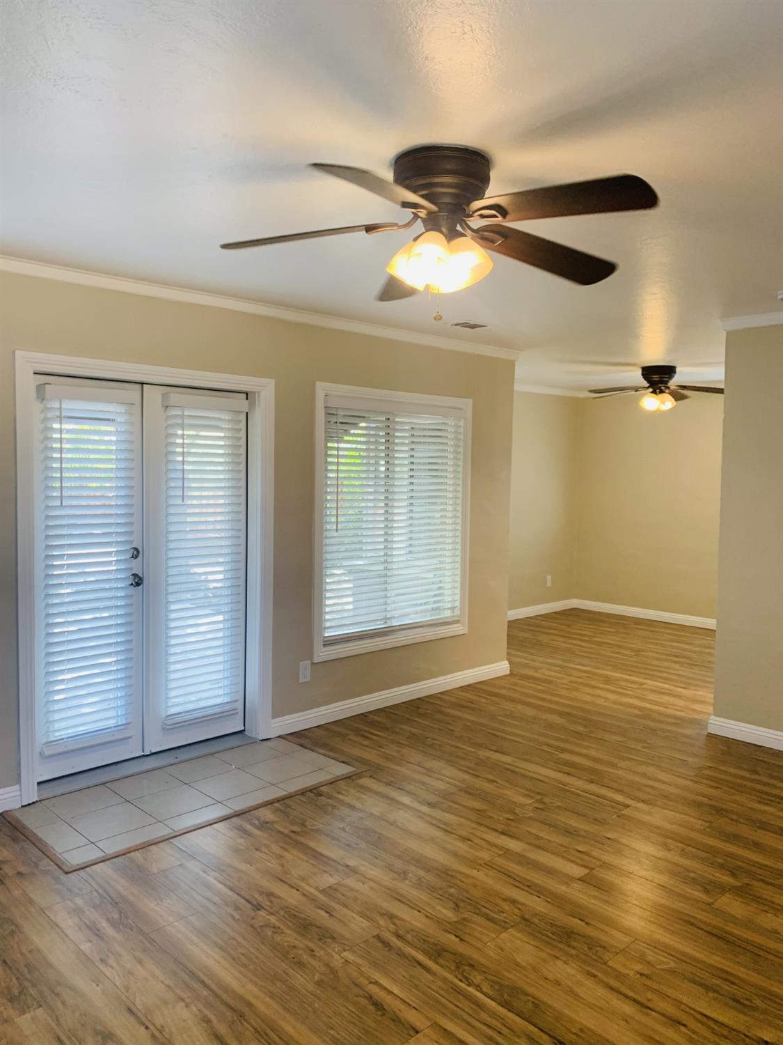 1163 Roxanne Avenue Hayward, CA 94542 - Photo 10 of 18 a view of an empty room with wooden floor and a window