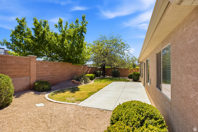 1630 East 2450th Street South, Unit 263 St. George, UT 84790 - Photo 20 of 24 Private backyard featuring a concrete patio, a section of turf, and gravel landscaping