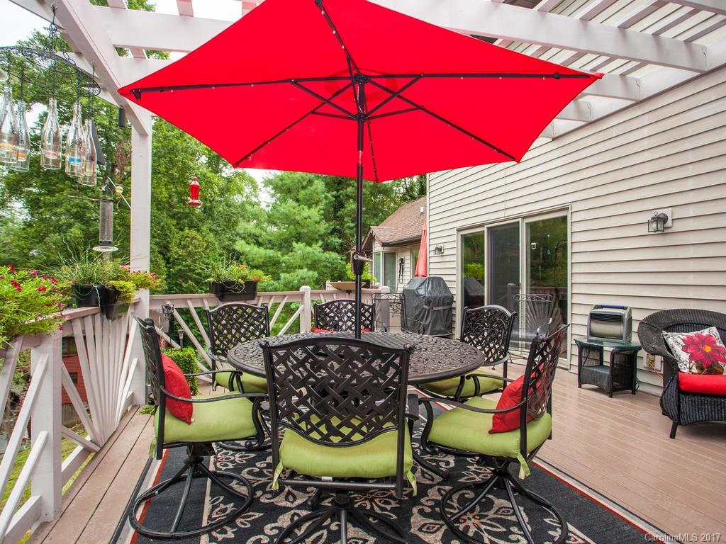 3419 Hebron Road Hendersonville, NC 28739 - Photo 12 of 22 a view of an outdoor sitting area with chairs and umbrella
