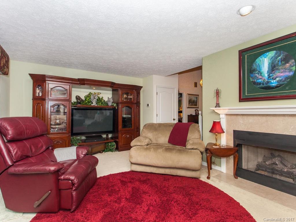 3419 Hebron Road Hendersonville, NC 28739 - Photo 3 of 22 a living room with furniture and a flat screen tv