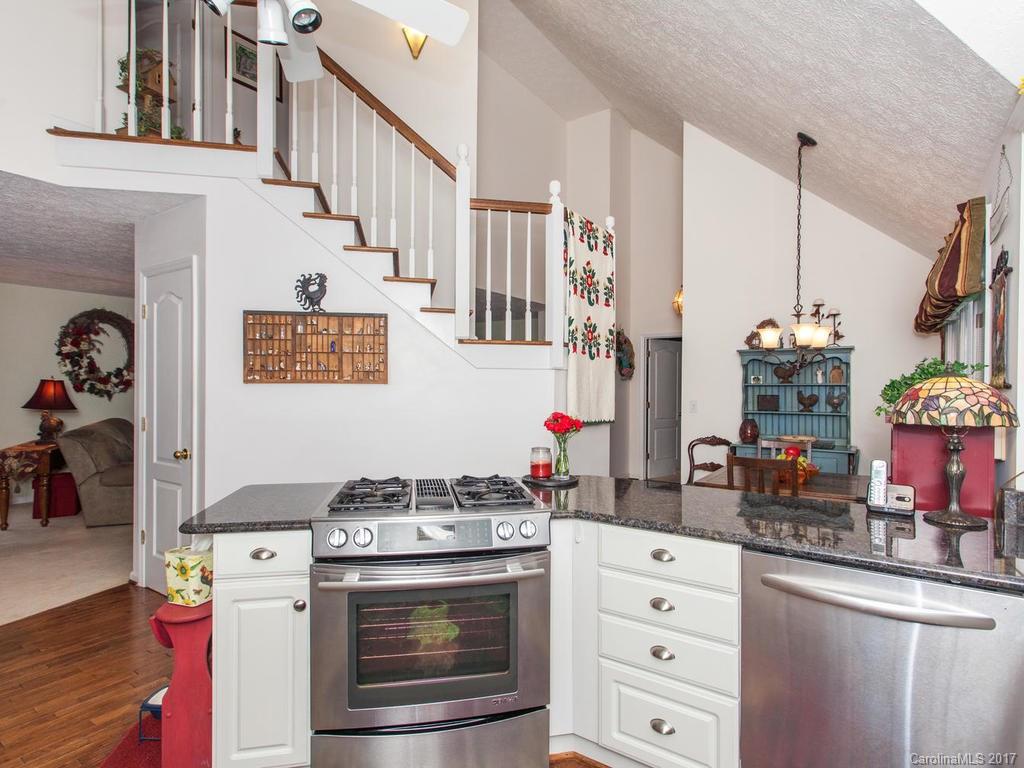 3419 Hebron Road Hendersonville, NC 28739 - Photo 4 of 22 a kitchen with appliances cabinets and a wooden floor