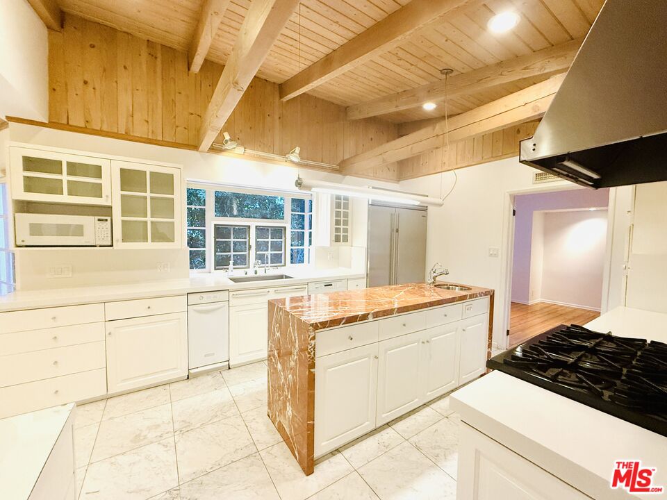 4031 Hollyline Avenue Sherman Oaks, CA 91423 - Photo 12 of 31 a kitchen with stainless steel appliances granite countertop a stove a sink and a microwave