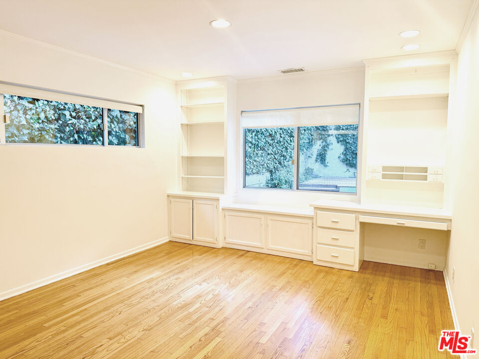 4031 Hollyline Avenue Sherman Oaks, CA 91423 - Photo 18 of 31 a view of an empty room with a window and wooden floor