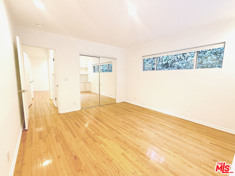 4031 Hollyline Avenue Sherman Oaks, CA 91423 - Photo 19 of 31 a bedroom with a bed and a table