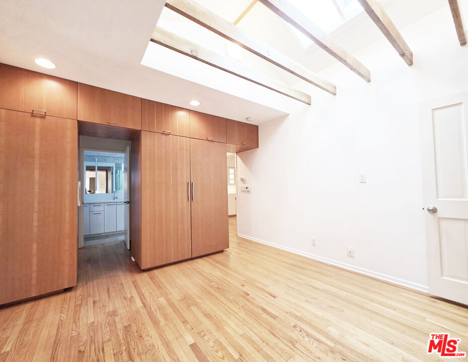 4031 Hollyline Avenue Sherman Oaks, CA 91423 - Photo 21 of 31 a view of an empty room with wooden floor