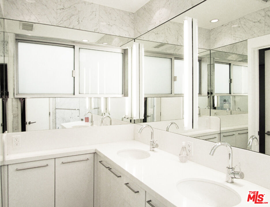 4031 Hollyline Avenue Sherman Oaks, CA 91423 - Photo 22 of 31 a bathroom with a sink and a large mirror