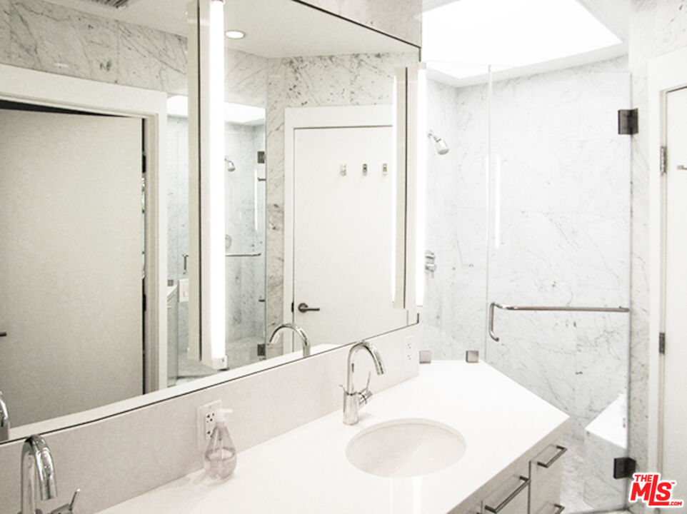 4031 Hollyline Avenue Sherman Oaks, CA 91423 - Photo 23 of 31 a bathroom with a sink and a mirror