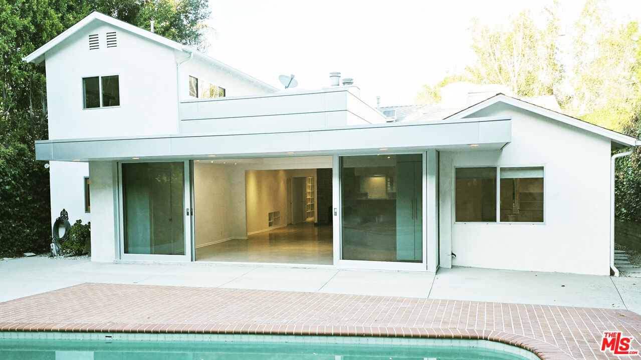 4031 Hollyline Avenue Sherman Oaks, CA 91423 - Photo 27 of 31 a view of a white house with a yard