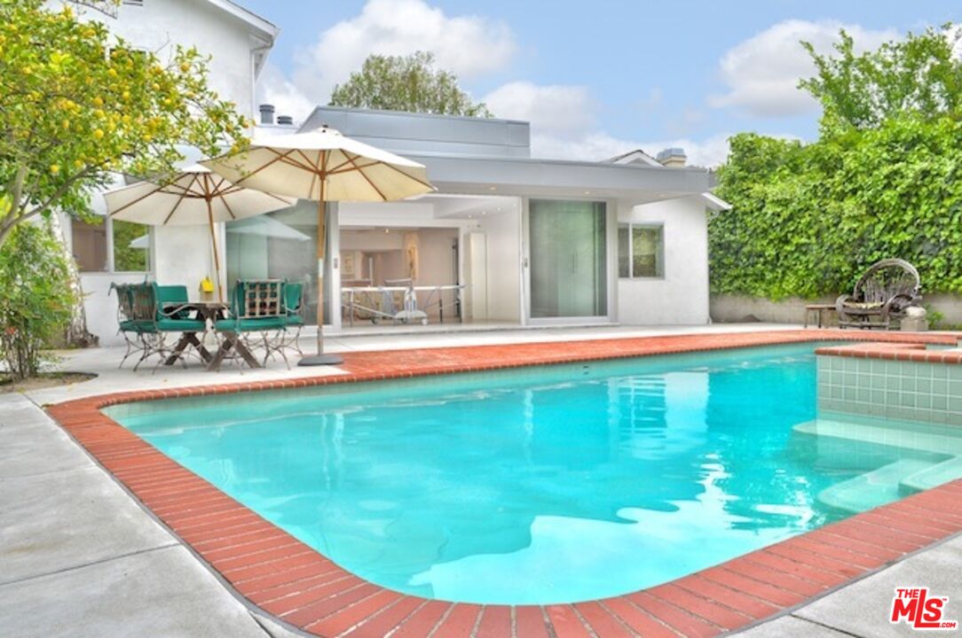 4031 Hollyline Avenue Sherman Oaks, CA 91423 - Photo 28 of 31 a view of a house with a swimming pool