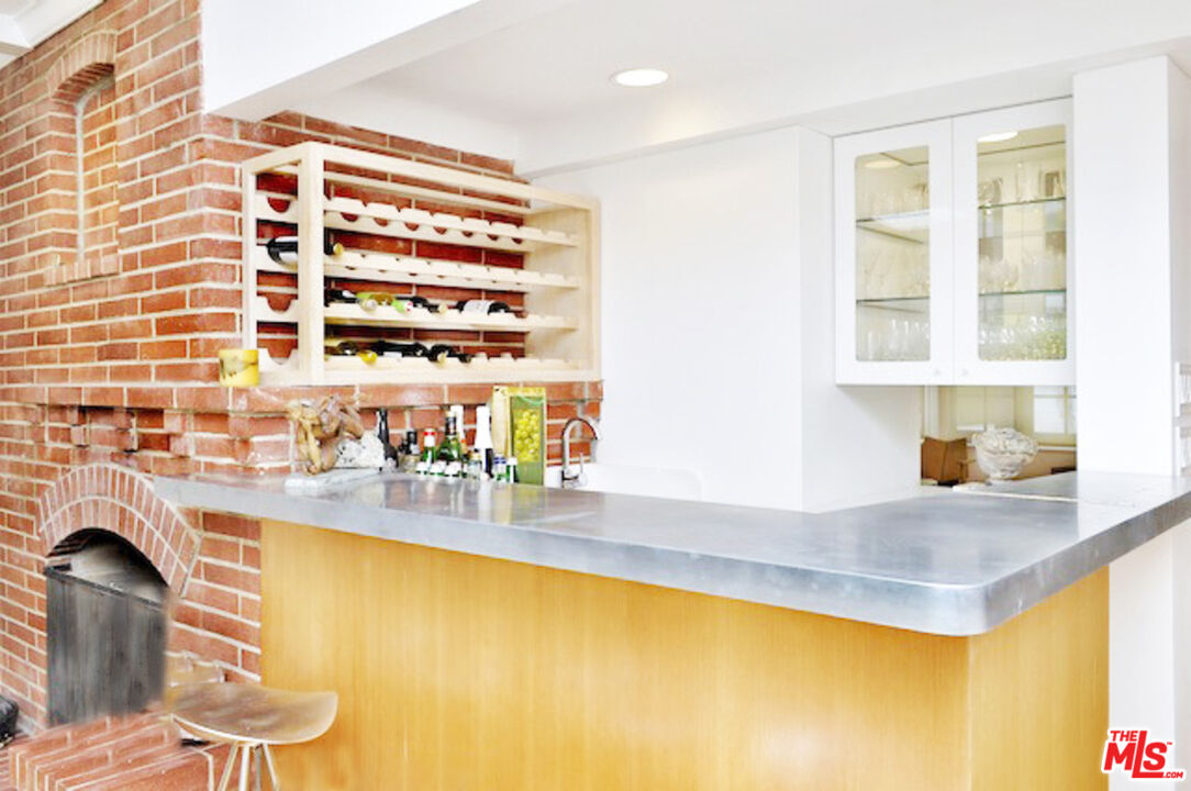 4031 Hollyline Avenue Sherman Oaks, CA 91423 - Photo 7 of 31 a kitchen with a sink and a view of living room