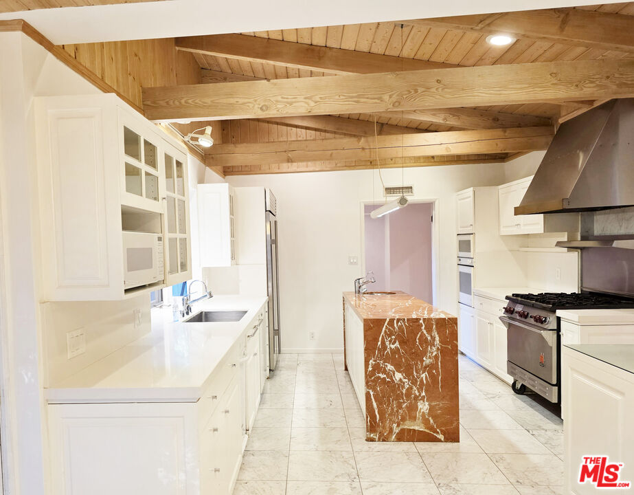 4031 Hollyline Avenue Sherman Oaks, CA 91423 - Photo 10 of 31 a kitchen with a stove and a refrigerator