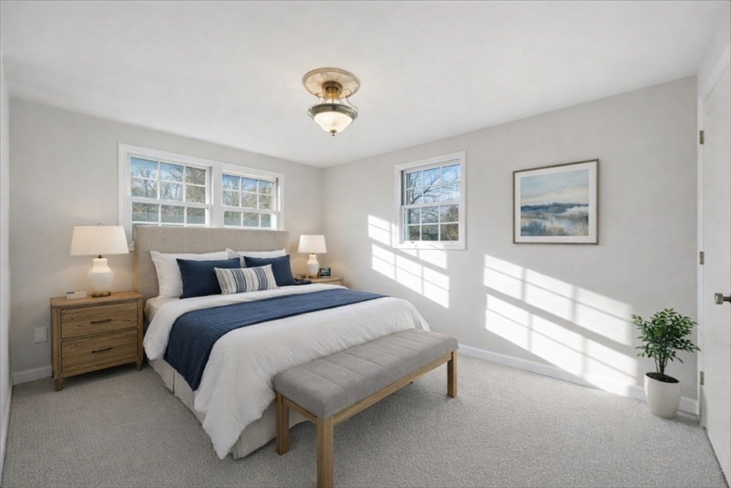 5 Pilgrim Circle, Unit C Methuen, MA 01844 - Photo 13 of 23 a spacious bedroom with a bed and a large window