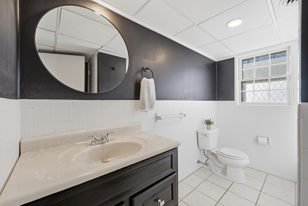 5 Pilgrim Circle, Unit C Methuen, MA 01844 - Photo 15 of 23 a bathroom with a sink a toilet and mirror