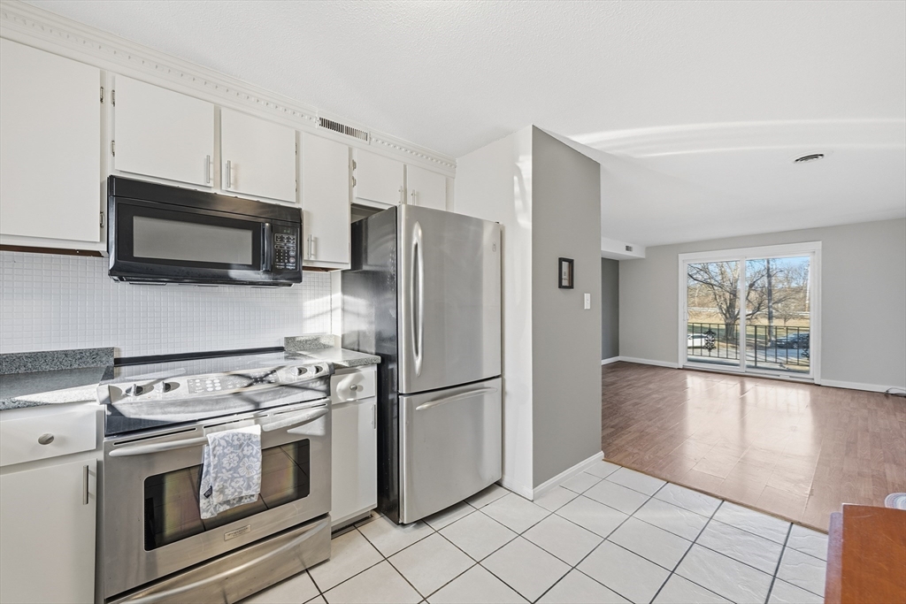 5 Pilgrim Circle, Unit C Methuen, MA 01844 - Photo 8 of 23 a kitchen with stainless steel appliances a refrigerator stove and microwave