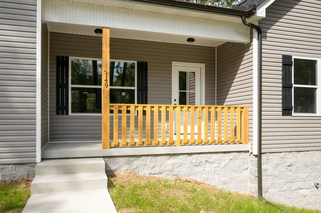 a view of a house with a small backyard