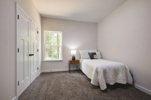 a bed room with a bed and a window