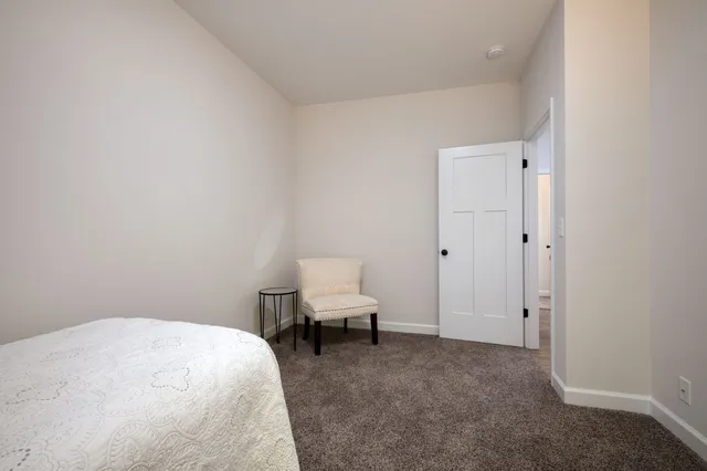 a bedroom with a bed and chair