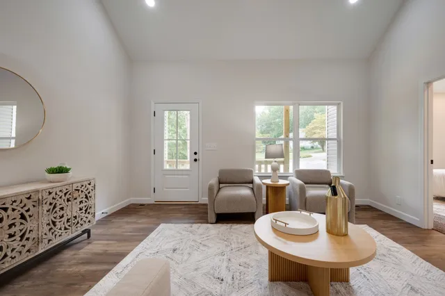 a living room with furniture and wooden floor