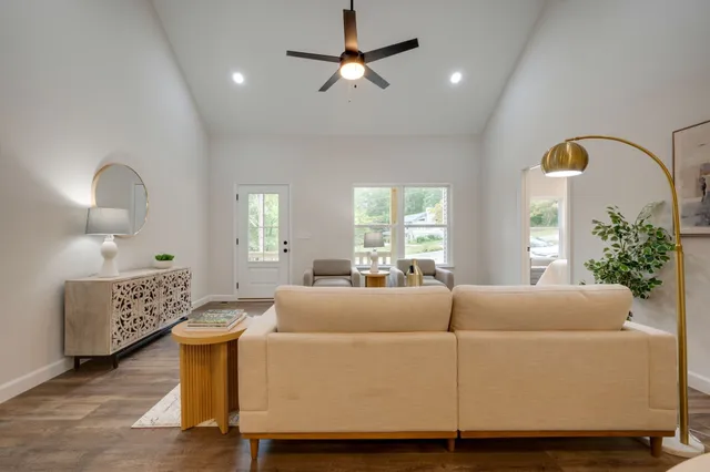 a living room with furniture a window and flowerpot