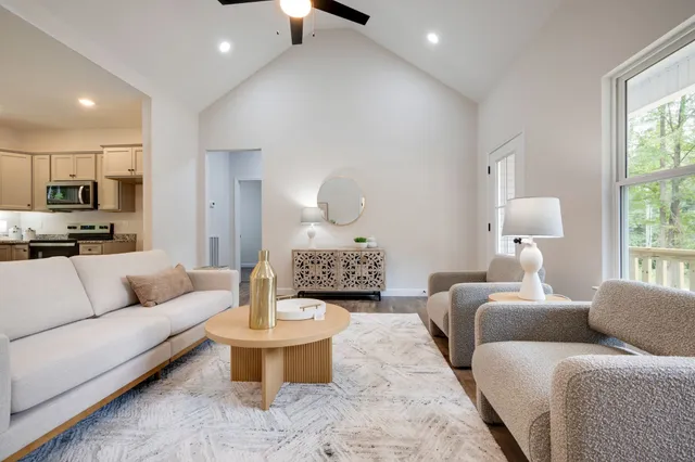 a living room with furniture and a large mirror
