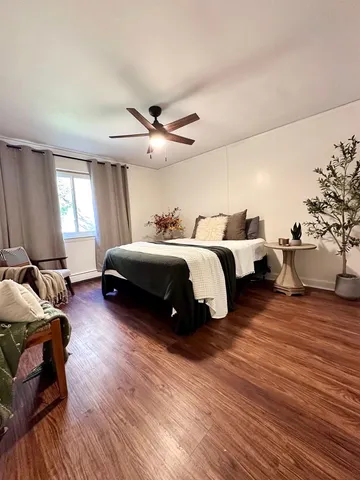 a spacious bedroom with a bed and a chandelier