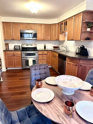 a kitchen with sink a microwave a stove and cabinets