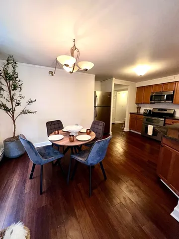 a view of a dining room with furniture wooden floor and chandelier