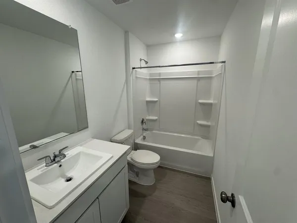 a bathroom with a sink toilet tub and shower