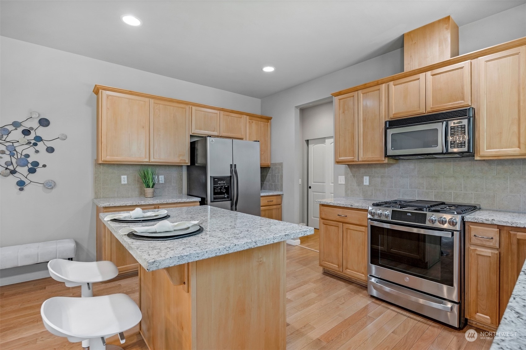 7 213th Street Southeast, Unit B Bothell, WA 98021 - Photo 11 of 34 a kitchen with stainless steel appliances a stove a sink a microwave a refrigerator and cabinets