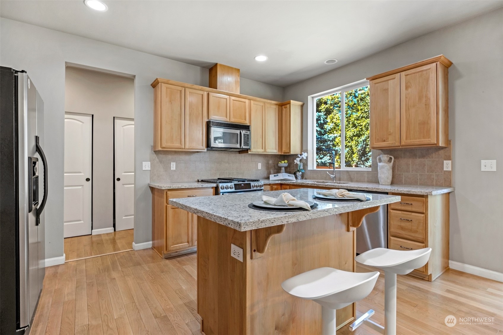 7 213th Street Southeast, Unit B Bothell, WA 98021 - Photo 12 of 34 a kitchen with stainless steel appliances granite countertop a stove a sink refrigerator and a microwave