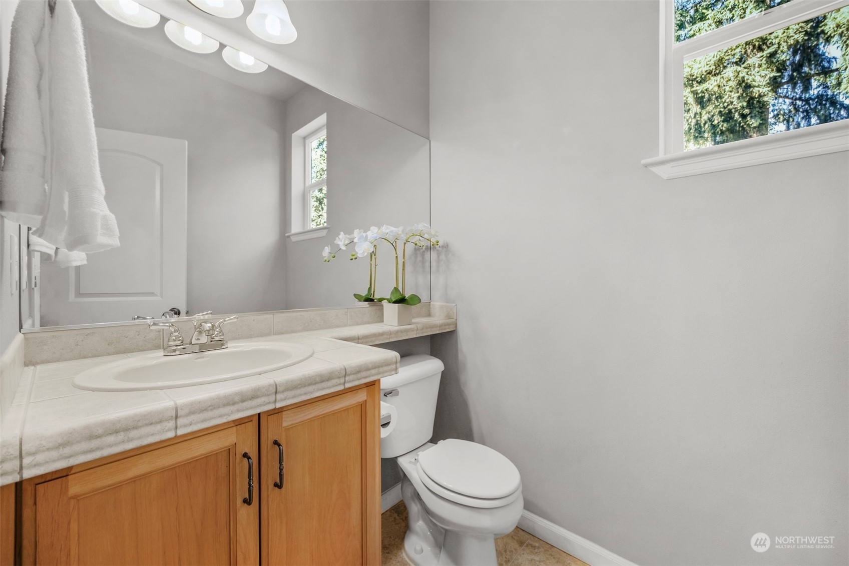 7 213th Street Southeast, Unit B Bothell, WA 98021 - Photo 14 of 34 a bathroom with a granite countertop sink toilet and mirror
