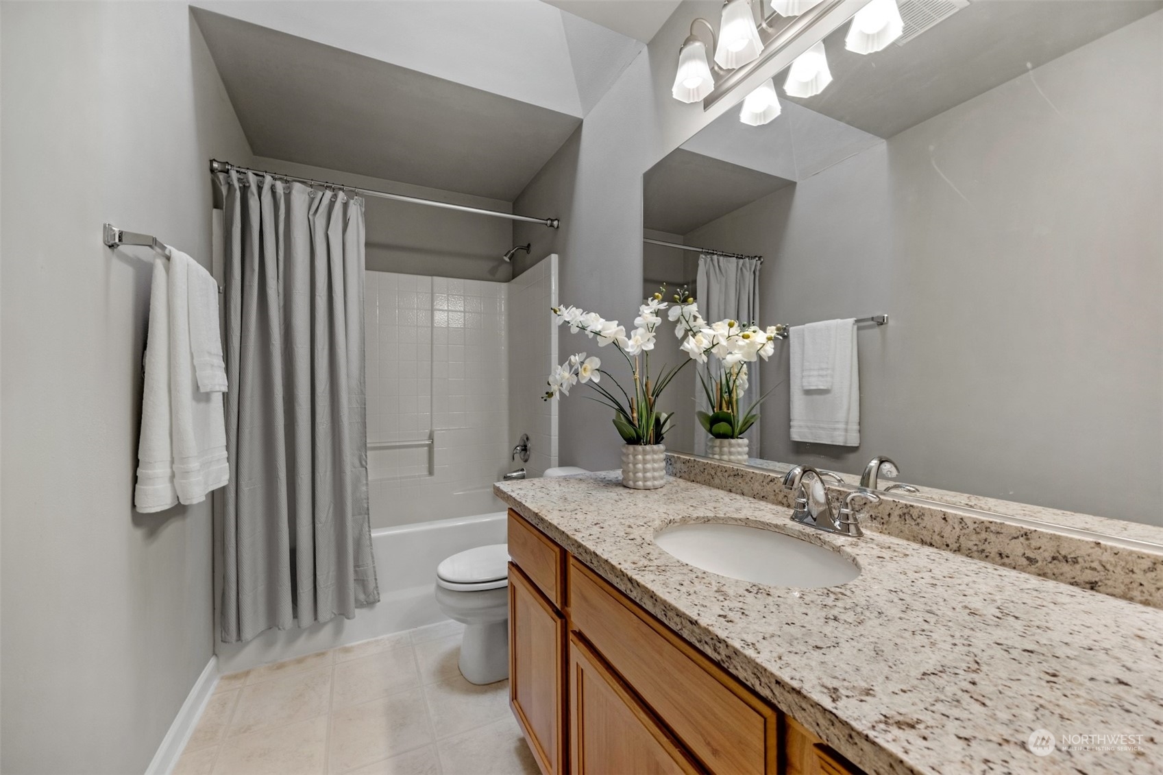 7 213th Street Southeast, Unit B Bothell, WA 98021 - Photo 24 of 34 a bathroom with a granite countertop sink a toilet and a large mirror