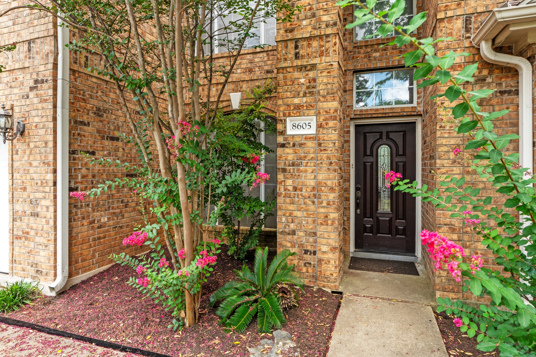 8605 Axis Drive Austin, TX 78749 - Photo 3 of 38 A classic brick exterior offers enduring charm and inviting curb appeal.