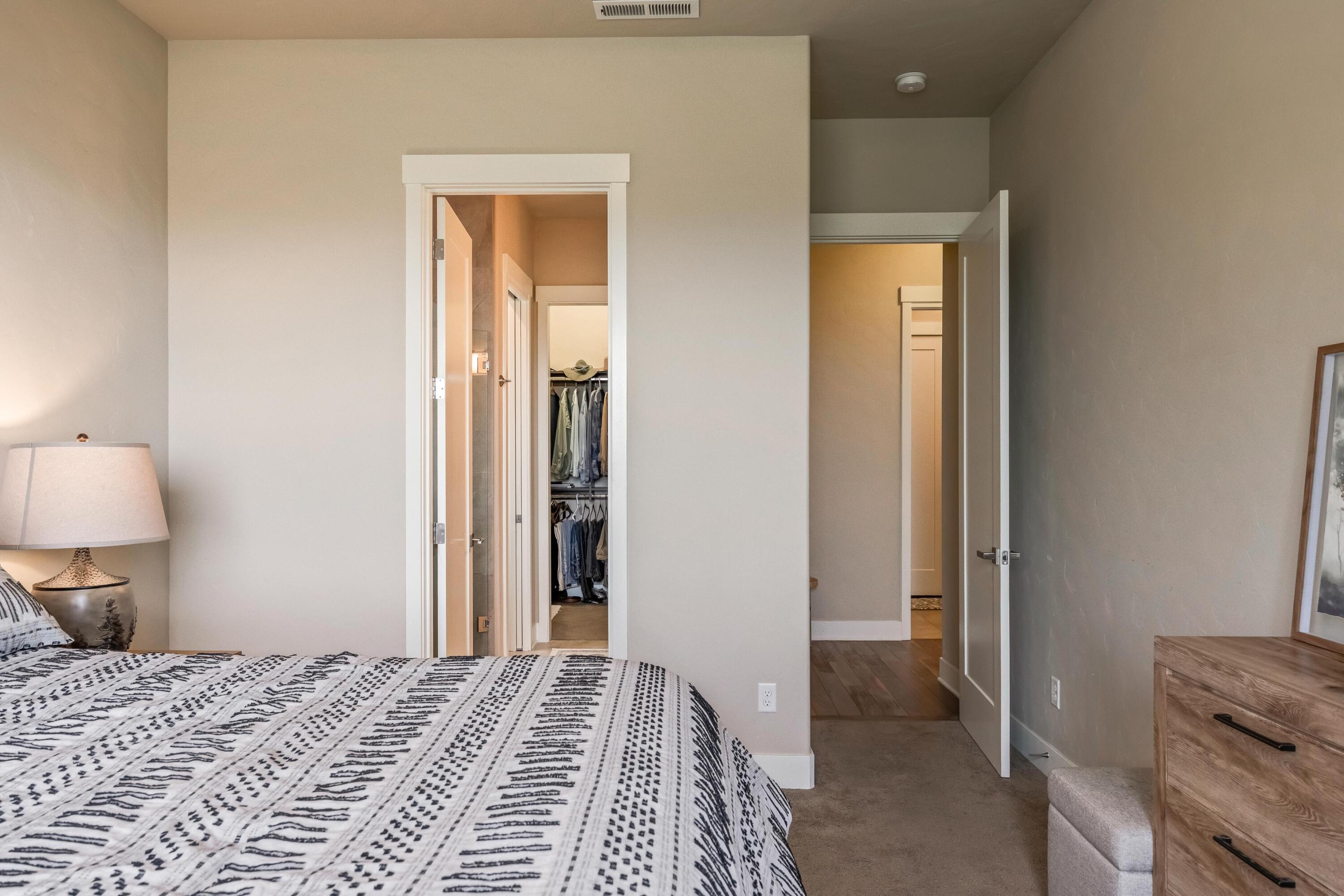 2375 Northwest Majestic Ridge Drive Bend, OR 97703 - Photo 22 of 28 a bedroom with a bed and a mirror