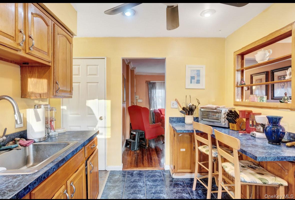 1024 Mahopac Road West Hempstead, NY 11552 - Photo 13 of 25 a very nice looking kitchen with granite countertop a stove a sink a dining table and chairs