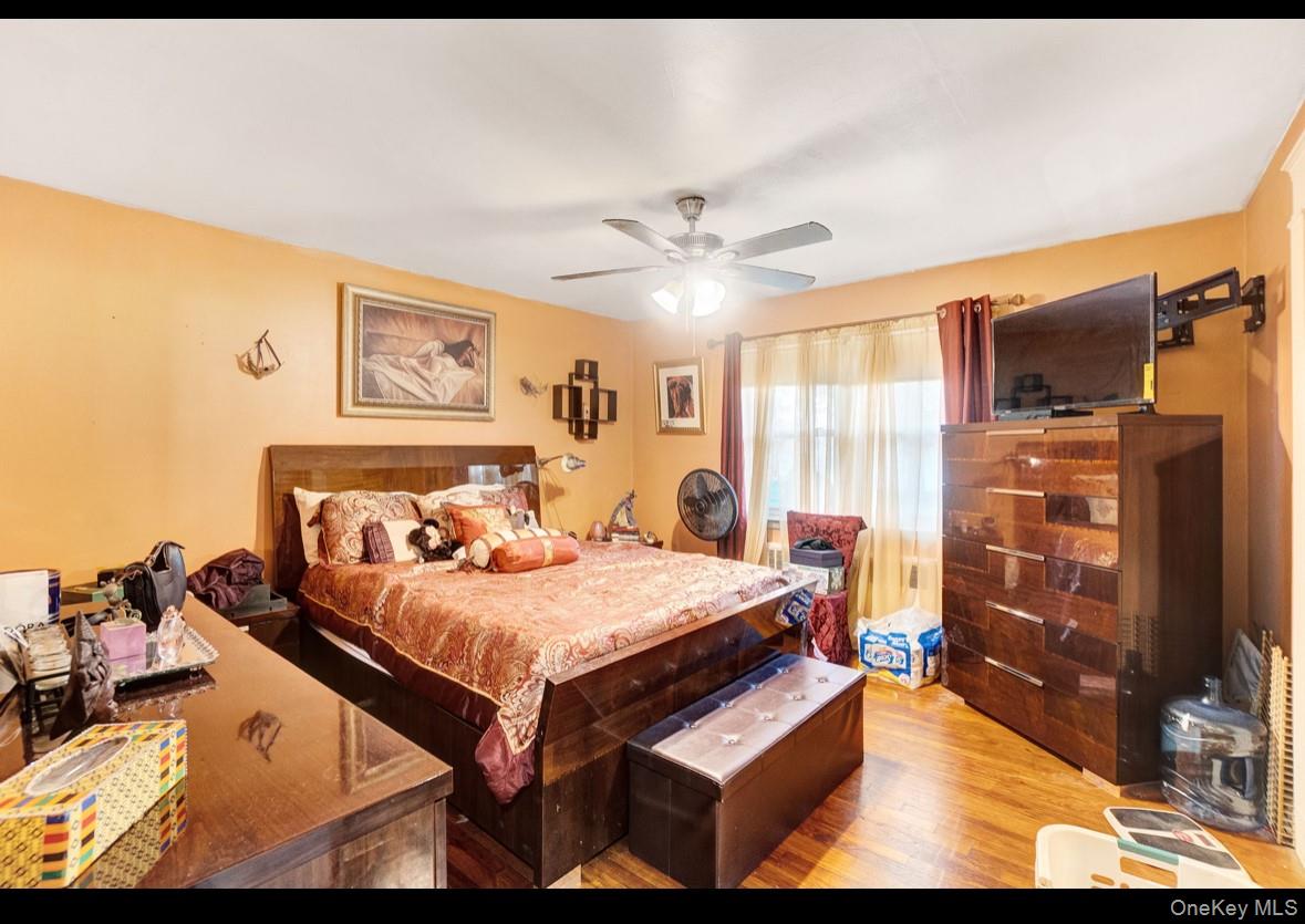 1024 Mahopac Road West Hempstead, NY 11552 - Photo 16 of 25 a bedroom with a bed and a flat screen tv