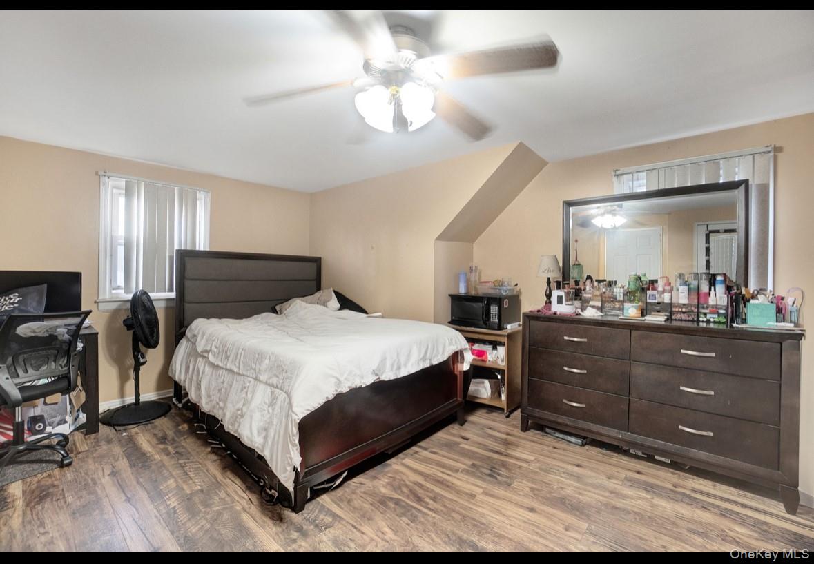 1024 Mahopac Road West Hempstead, NY 11552 - Photo 18 of 25 a bedroom with a bed and a chandelier