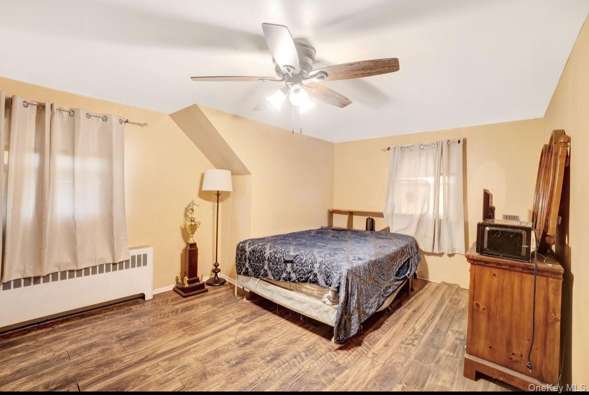 1024 Mahopac Road West Hempstead, NY 11552 - Photo 20 of 25 a spacious bedroom with a bed and a flat screen tv