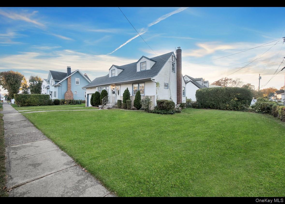 1024 Mahopac Road West Hempstead, NY 11552 - Photo 2 of 25 a view of a big house with a big yard and potted plants
