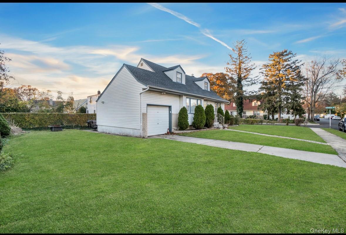 1024 Mahopac Road West Hempstead, NY 11552 - Photo 4 of 25 a view of a house with a big yard and palm trees