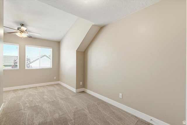 857 225 South Springville, UT 84663 - Photo 14 of 23 Vaulted ceiling room featuring two windows with horizontal blinds, a ceiling fan with integrated lighting, neutral-toned walls, and plush carpet flooring