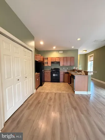 a large kitchen with stainless steel appliances granite countertop a large counter top and oven