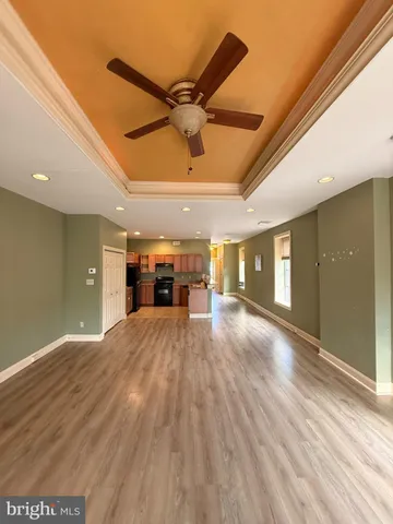 a view of a livingroom with a ceiling fan and window