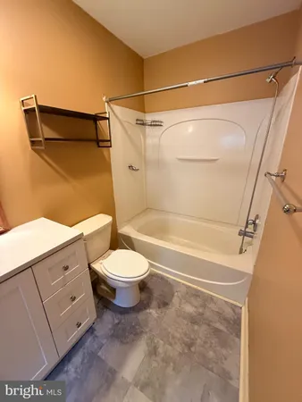 a bathroom with a toilet and shower