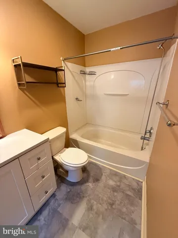 a bathroom with a toilet and shower